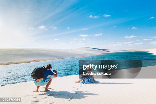 Couple taking a photograph at Lençois Maranhenses